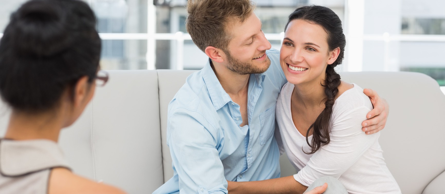 Happy couple reconciling at therapy session in therapists office